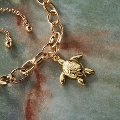 "Buy the 14K Gold Plated Turtle Charm by Bead Landing™ at Michaels. Create custom jewelry for your self or loved ones with this stylish charm. This 14K gold plated charm is perfect for commemorating special people and events in your life. Create custom jewelry for your self or loved ones with this stylish charm. This 14K gold plated charm is perfect for commemorating special people and events in your life. String it onto a gold chain or hang it from a bracelet or keychain for a personalized touc Sea Turtle Bracelet, Bead Landing, Turtle Bracelet, Turtle Charm, Special People, Gold Chain, Custom Jewelry, Gold Chains, Gold Plate