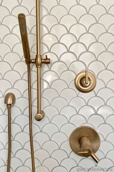 the shower head and hand shower faucet are gold