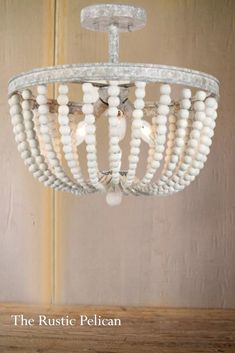 the rustic pelican chandelier is made from wood beads