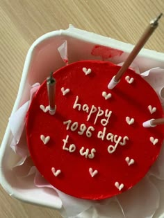 a red cake with white hearts on it that says happy yogsday to us