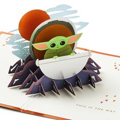 a pop up card with an image of the child yoda in a paper egg