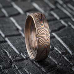 * Price may vary depending on ring size, please inquire with us directly with your needed size for accurate pricing! This hand crafted Mokume Gane band is shown in the Vortex pattern and the Fire metal combination with an etched and oxidized finish and a low dome profile. The Fire palette features 14k yellow gold, 14k red gold and sterling silver. Width Shown: 6mm Size Shown: 8.5 Palette: Fire Pattern: Vortex Finish: Etched + Oxidized Profile: Low Dome Price does NOT include stones or setting fees. We care about customer service and would like to hear from you! Please contact us to help create your treasured item, we take your concerns and requests to heart and will work together to create your unique designs SPECIAL PRICING FOR SETS. CONTACT US WITH YOUR DESIRED WIDTHS FOR A QUOTE All Arn Mokume Gane Ring, Fire Pattern, Jewelry Board, Mokume Gane, Jewelry Boards, The Fire, Red Gold, Precious Metals, Wedding Inspo