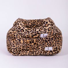 the leopard print bean bag chair has two white tags on it's side and one is