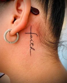 a woman's behind the ear has a cross tattoo on her left side ribcage