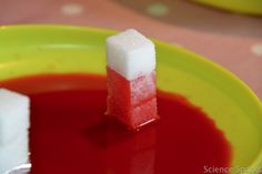 two pieces of cake sitting on top of a yellow bowl filled with red and white liquid