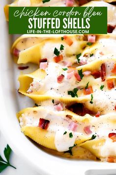 a white plate topped with stuffed shells covered in cheese and bacon next to parsley