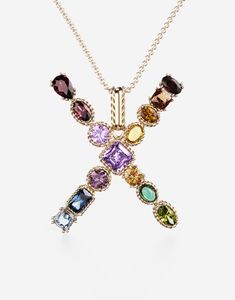 The yellow gold pendant is illuminated by a veritable rainbow of natural gemstones such as topaz, garnet, amethyst, citrine, peridot and tourmaline. the shades of their colours, dominated by blue, green, purple, red, pink and yellow, evoke the warm atmospheres of Sicily. The multiple shapes of the crystals are also emphasized by the bezels, which alternate twisted thread processing and smooth surfaces. The chain, also in yellow gold and wearable in different lengths, includes a teardrop pearl at the end and a small pendant DG logo, which for the very first time embellishes a Dolce & Gabbana Fine Jewellery creation. Technical specifications. Gold yellow 18 Kt. Length. 15.8 + 2 + 2 inches, 40 + 5 + 5 cm adjustable. Gemstones., n.1 round intense purple amethyst, n.1 square with removed sharp Rainbow Alphabet, Logo Jewelry, Gold Topaz, Monogram Necklace, Yellow Citrine, Gold Necklace Women, Green Peridot, Yellow Gold Pendants, Small Pendant