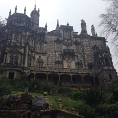 an old castle like building with many windows and balconies on the top floor