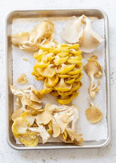 a pan filled with sliced mushrooms on top of a table