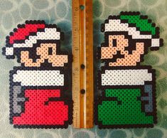 two pieces of perler bead art are next to a ruler