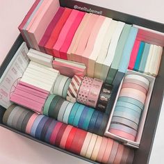 a box filled with lots of different colored ribbons