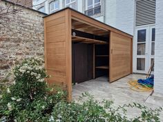 an outdoor storage shed with the door open