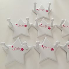 six white stars with red writing on them are arranged in the shape of a crown