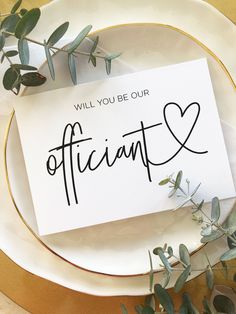 a piece of paper that says, will you be our officiant? on top of a plate