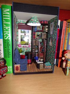 there is a doll house in the middle of bookshelves