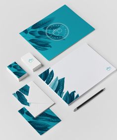 the stationery and business cards are designed to look like tropical leaves, with a clock in the background