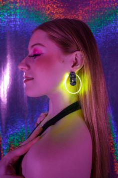 Whether you're hitting the club, attending a concert, or out at a party, the spotlight will follow you everywhere you go with these Neon Nood earrings. Made with a thin, flexible, and super bright "filament" of LEDs, these are our lightest design. Like all our designs, these earrings are sound-reactive, and offer multiple modes: pulsing, flashing, "breathing" and steady on. These earrings feature long battery life, light-weight and fun, neon colors. Choose from Blue, Pink, Yellow, and Red/Orange Champagne Room, At A Party, Follow You, Neon Colors, The Club, Battery Life, Pink Yellow, Shop Necklaces, Derby