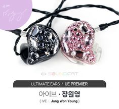 two earphones with pink and black crystals on them