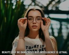 a woman wearing glasses and holding her hands up to her face with the caption, beauty may be dangerous but intelilince is left behind