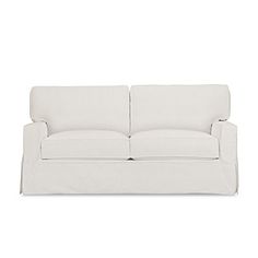 a white couch sitting on top of a white floor