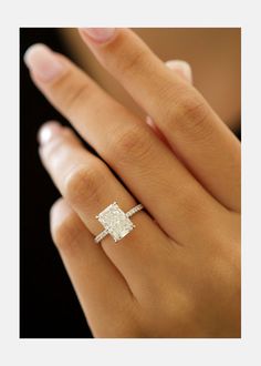 a woman's hand with a diamond ring on it