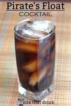 a tall glass filled with ice sitting on top of a table