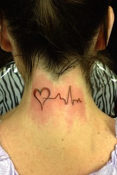 a woman with a heart and heartbeat tattoo on her neck