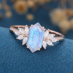 a ring with a blue stone surrounded by white diamonds