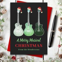 a christmas card with three guitars on it