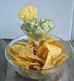 a bowl filled with chips and guacamole dip