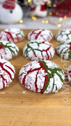 several decorated cookies sitting on top of a wooden table