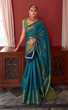 Our custom-made sarees are designed for effortless elegance, tailored specifically for each client. Each saree includes an unstitched blouse piece for personalisation. Featuring pre-pleated pleats and a simple skirt-like draping style, our sarees ensure comfort even during extended wear. The saree is crafted from blended silk and measures 5.5 meters in length, providing ample fabric for various draping styles. Additionally, the unstitched blouse piece, measuring 0.8 meters, can be customised at an additional cost to perfectly complement your saree. The pallu is left unstitched, allowing for versatile styling options--whether you prefer an open pallu or neatly pleated look. Fabric: Blended Silk  Saree Length: 5.5 meters  Blouse Piece: 0.8 meter  Time to Ship: 7 to 8 working days Open Pallu Saree Style, Peacock Color Saree, Peacock Saree, Fancy Dresses For Girls, Bernadette Banner, Ready Made Saree, Draping Styles, Simple Skirt, Fashion Fails