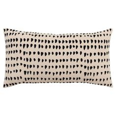 a black and white pillow with hearts on it