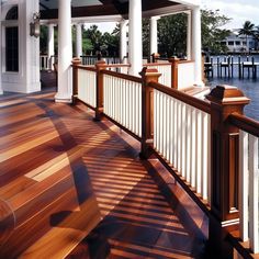 a wooden deck with white pillars and columns