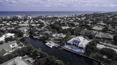 an aerial view of houses and boats in the water