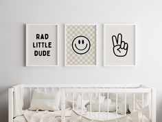 three posters on the wall above a crib in a white room with checkered sheets