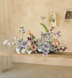 a wooden table topped with lots of flowers