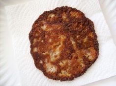 an image of a fried food item on a paper towel in the shape of a circle