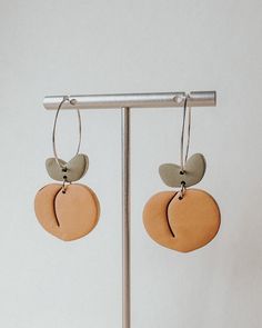 Handmade polymer clay peach earrings with your choice of gold or silver metal Ear wire closure Hypoallergenic metal - free of nickel & lead Clay earrings are lightweight & comfortable enough for all-day wear Due to handmade nature, slight imperfections and differences may occur in each pair of earrings Orange Clay Jewelry For Gifts, Small Hoop Polymer Clay Earrings For Everyday, Handmade Peach Dangle Jewelry, Orange Minimalist Earrings For Everyday, Nickel-free Polymer Clay Jewelry For Everyday, Minimalist Orange Earrings For Everyday, Everyday Small Hoop Earrings In Polymer Clay, Everyday Nickel-free Polymer Clay Jewelry, Everyday Minimalist Orange Earrings