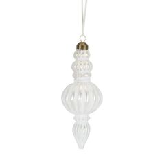 a white glass ornament hanging from a string on a white background, with a gold - plated top