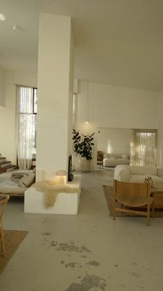 a living room filled with furniture and lots of windows next to a white floor covered in dirt