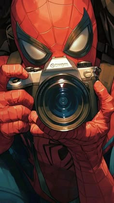 a person holding a camera in front of their face with spider - man's eyes