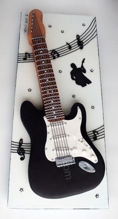 a cake with a guitar and musical notes on it