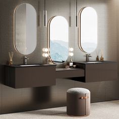 a bathroom with two sinks and three mirrors on the wall next to an oval window