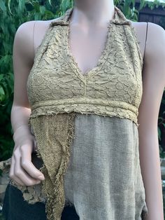 Introducing the Earthy Pixie Halter, our Lace and Rag Cotton Asymmetrical Boho Hippie Tribal Open Tie-Back Summer Halter Top. This unique piece is crafted with intricate lace detailing and soft, breathable rag cotton, perfect for those warm summer days. The asymmetrical design adds a touch of avant-garde style, while the boho hippie tribal influences bring a free-spirited charm to your wardrobe. Featuring an open tie-back for an adjustable fit, this halter top is both comfortable and stylish, ma Cheap Bohemian Halter Top, Summer Lace Top With Patchwork, Summer Lace Patchwork Tops, Bohemian Cotton Lace Patchwork Top, Summer Halter Tops, Pixie Fairy, Pixies Fairies, Avant Garde Fashion, Boho Festival