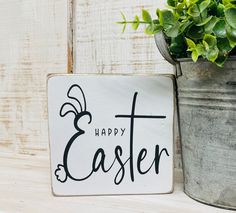 a sign that says happy easter next to a potted plant