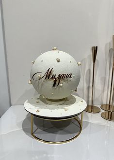 a white ball with the word magnana on it sitting on a stand next to other items