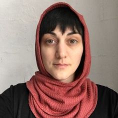 a woman wearing a red scarf over her head