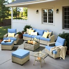 a patio with wicker furniture and blue cushions