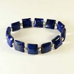 "- Gorgeous Lapis Lazuli Beaded Gemstone Stretch Bracelet in Puff Square Beads with 925 Sterling Silver Corrugated Beads. See Photos #1-3. - Adorable 1/2\" Puff Square Lapis Lazuli Polished Beads. - Pretty 925 Sterling Silver 4mm Corrugated Beads as spacers and accents. - Stretch Bracelet measures 7\".  - Stretch Bracelet is Latex Free. - If you prefer a different Length, we are happy to customize for you at no cost. Remember to leave a little \"wiggle\" room when measuring the wrist. Give us a Square Beads, Lapis Lazuli Beads, Rainbow Earrings, Blue Jewelry, Gorgeous Bracelet, Pink Earrings, Latex Free, Earrings Collection, Glass Earrings